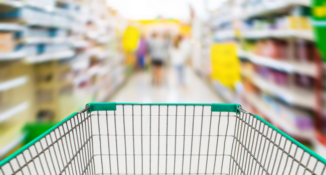 Photo of a shopping basket and an out-of-focus shop interior behind it